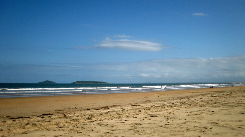 depicts harbour beach at mackay marina north queensland. blue skies cool water and hot sun. **Note, slight graininess,  best at small sizes.